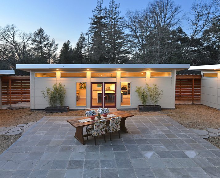 A completed detached accessory dwelling unit lit at dusk